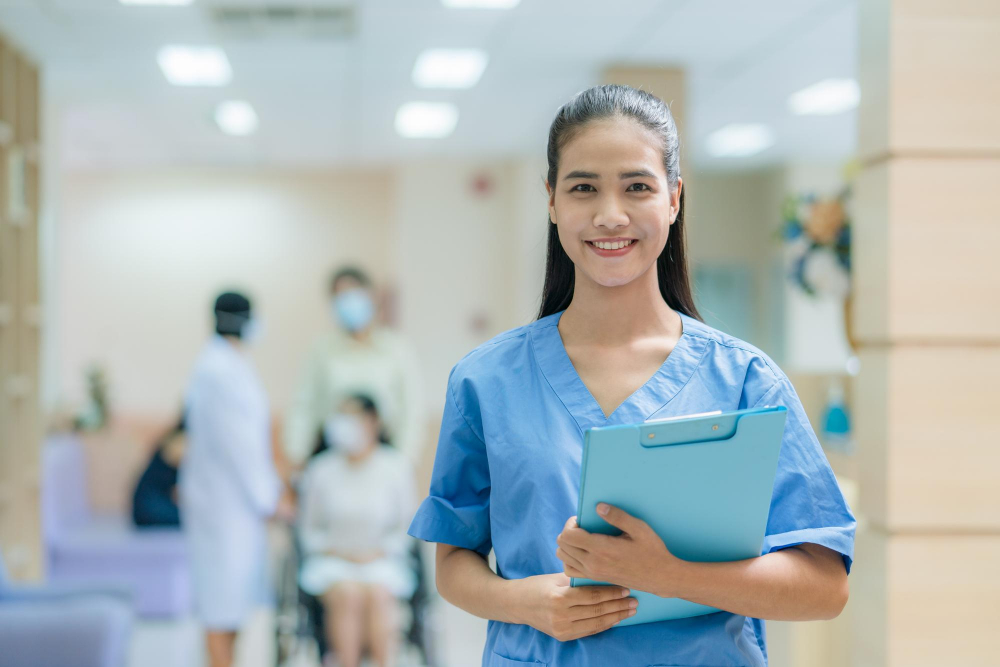 Asian female nurse in uniform working in hospital with doctor and patient on wheelchair background
